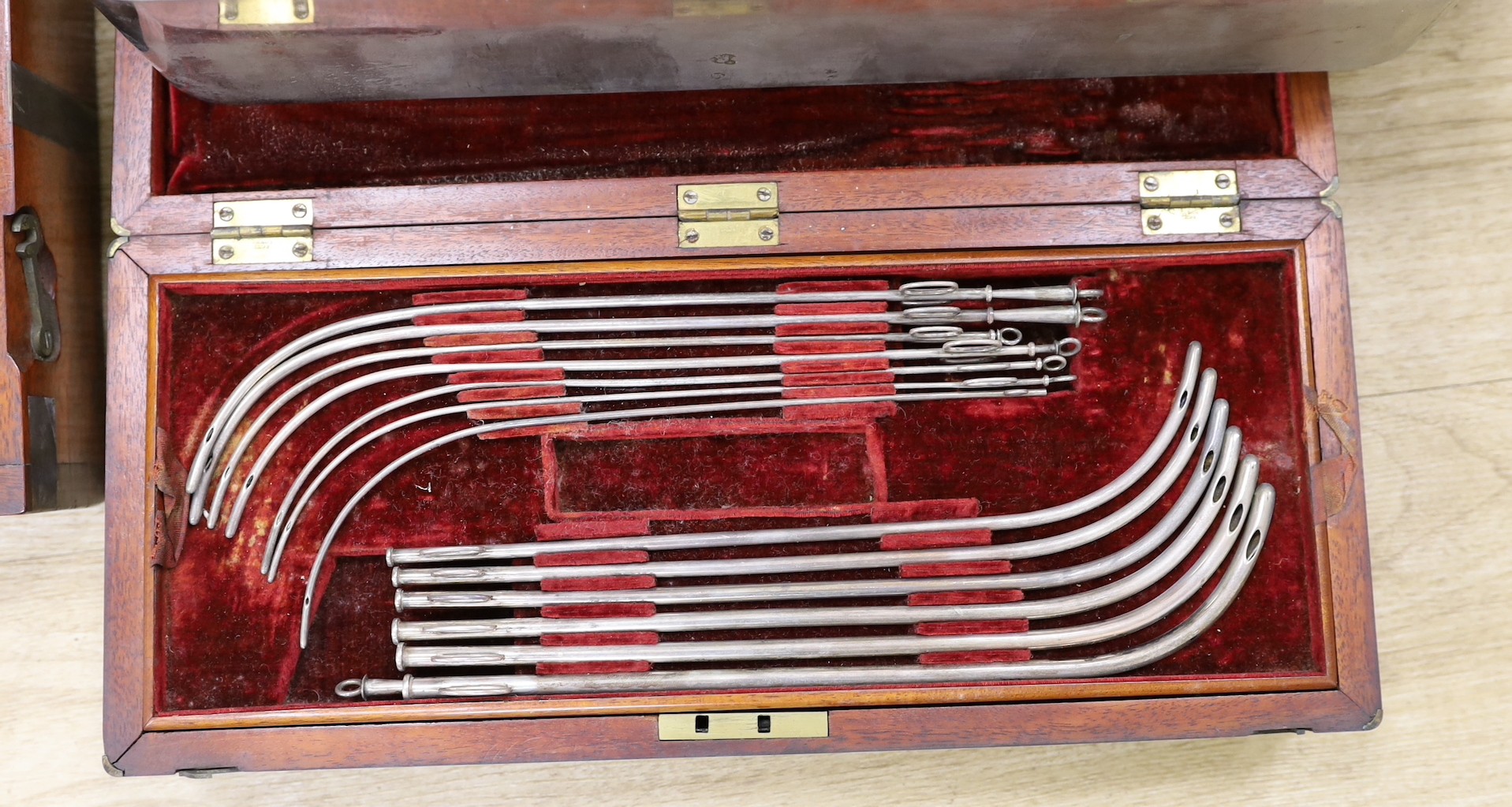 A 19th century mahogany cased field surgeon’s set (incomplete), and other field medical equipment, all three in brass banded mahogany boxes
